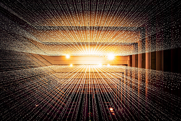 Photo of strings of lights hanging down from a ceiling.