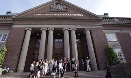 people standing on the steps of a large building