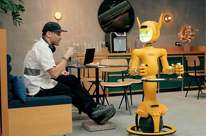 Robot serving a man a beverage.